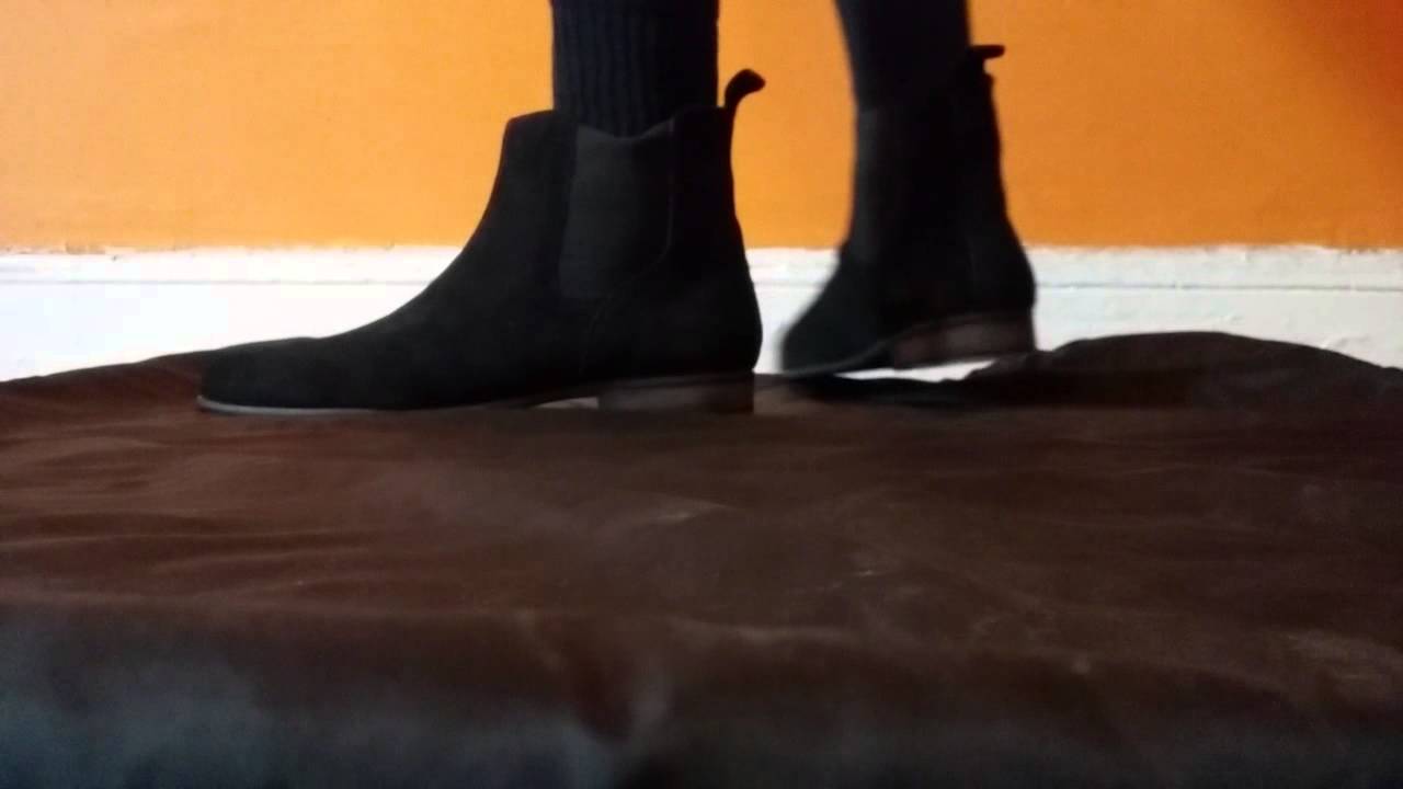 black chelsea boots on feet