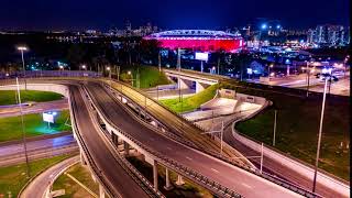 night timelapse aerial view of a freeway intersection traffic trails in