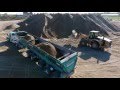 Caterpillar 980G Loading Live Bottom Trailer at a Sand and Gravel Pit