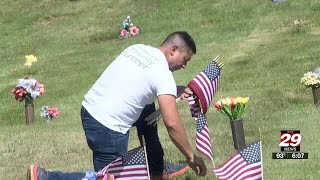 Volunteers place hundreds of flags at Monticello Memory Garden ahead of Memorial Day
