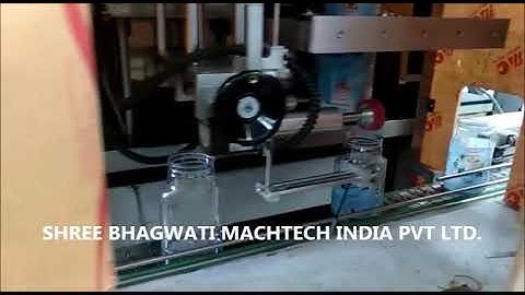 Pet jar shrink sleeve label applicator with heat tunnel