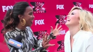 Simon Cowell is turning and rubbing Demi Lovato!