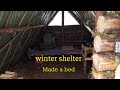 winter shelter in forest. bushcraft.made a bed.