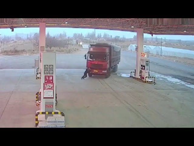 Driver run over by own truck after trying to stop it using his body