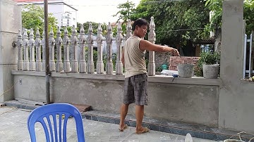 Hàng rào con tiện bê-tông