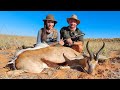 Huntress hunting a springbuck in the red dunes of the namibian kalahari heart kidney liver braai