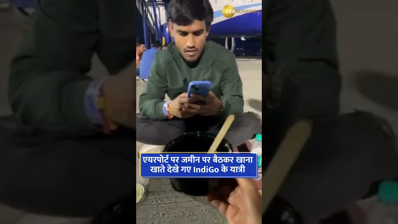 Indigo passengers sitting on the ground and eating food