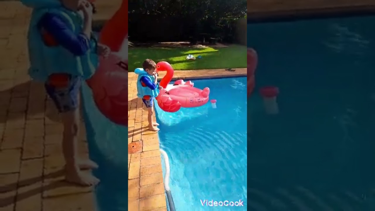 jumping in the pool with a life jacket