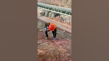 Construction site: Worker precisely locates anchor, details matter