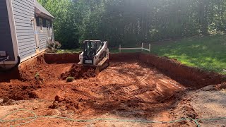 Excavating a foundation with bobcats