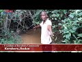 A resident of Korukoru showing Nigerian Tribune round Korukoru community’s main source of water.