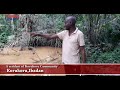 A resident of Korukoru showing Nigerian Tribune round Korukoru community’s main source of water.