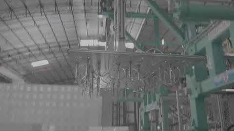 SMED Shape moulding machine with robot arm to pick and stack products.