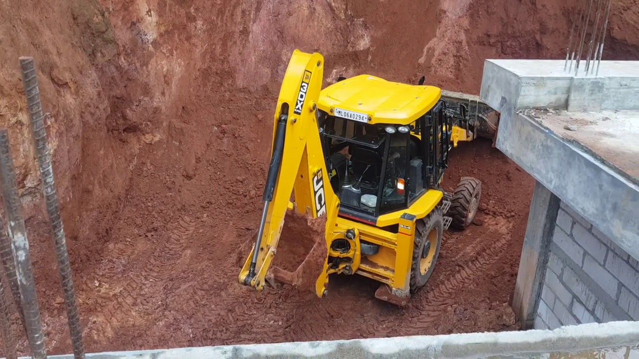 Jcb backhoe loader clearing landslide