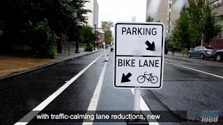 Defenders And Opponents Clash Over City’s First Protected Bike Lane