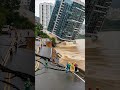 High-Rise Apartment Collapses Beside the Riverbank