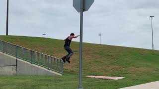 Inline skater grinds handrail then falls forward on landing
