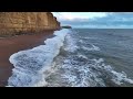 Westbay coastline start of Chesil beach Dorset flying above the water