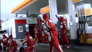 Michael schumacher and pitcrew doing f1 style pitstop