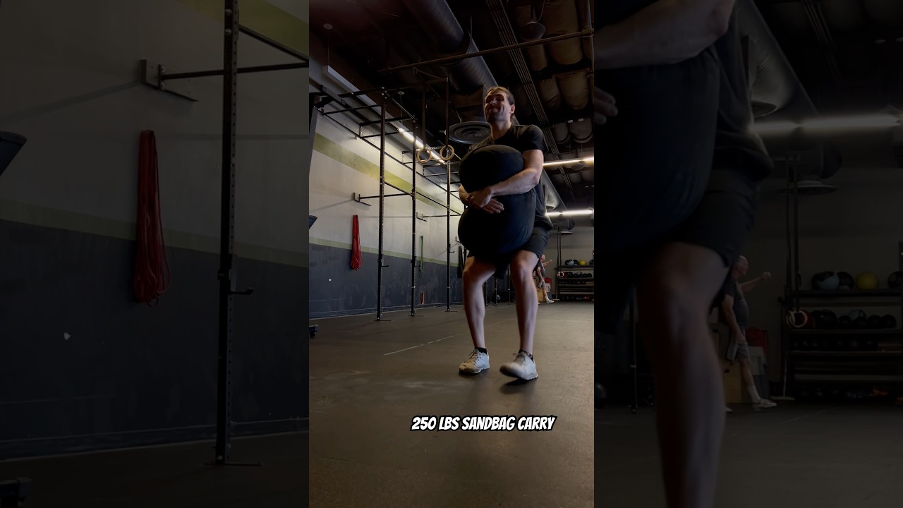 250lbs sandbag carry #fitness #workout #shorts