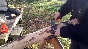 Debark maple log with a drawknife