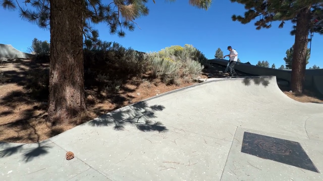 Skateboarder 50 50 grinds spine of ramp then falls and lands on sensitive area