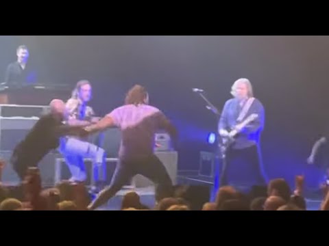 THE BLACK CROWES' Rich Robinson hits fan on stage with his guitar to remove him from stage