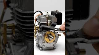 Macro close-up of a miniature silver model engine with cooling fins and gold-toned #shortvideo