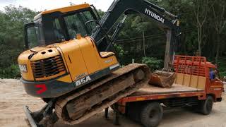 Mini excavator hyundai 85A loading for transportation.