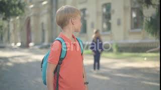 Camera Approaches To Cute Caucasian Boy Looking Back At Clmates Playing Soccer And Showing Th...