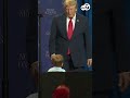Trump corrals toddler wandering near edge of stage