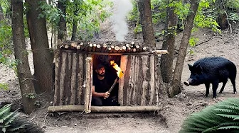 Building a primitive survival shelter escaping from a wild boar