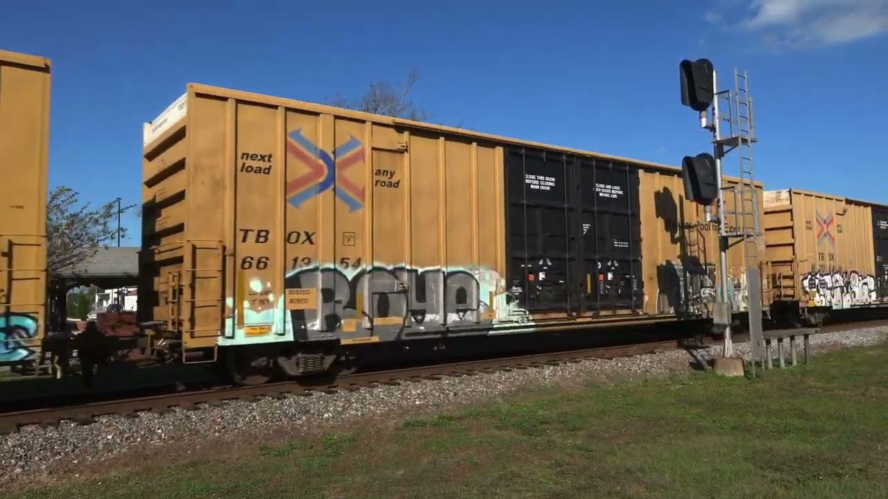 Plant City, FL, USA. CSX locomotive 2523 with train headed towards Tampa across the diamond.
