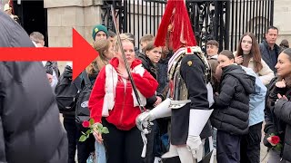 she brings him a rose. guard shouts in her face!