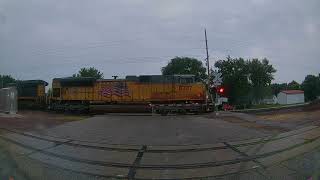 Eastbound Union Pacific coal train with CSX locomotive in the rain in Colo, Iowa