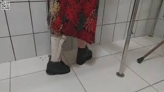 Polio Handicapped Woman Walking With Ortho Boots.