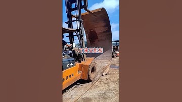 Forklift Handling Massive Steel Pipe: Heavy Lifting in Action