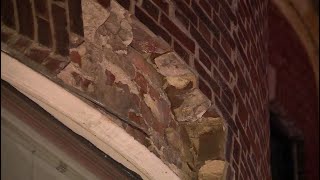 Bricks fall from building, injure woman below