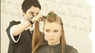 Hairdresser with short pixie haircut giving a long haircut for this beautiful client