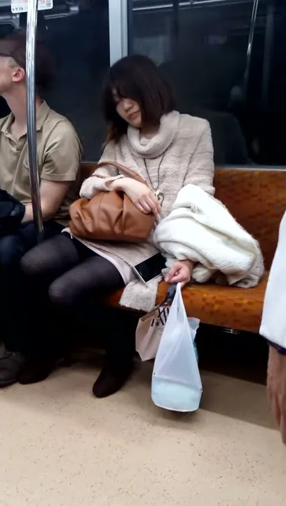 Drunk girl sleeping on the train in Tokyo, Japan