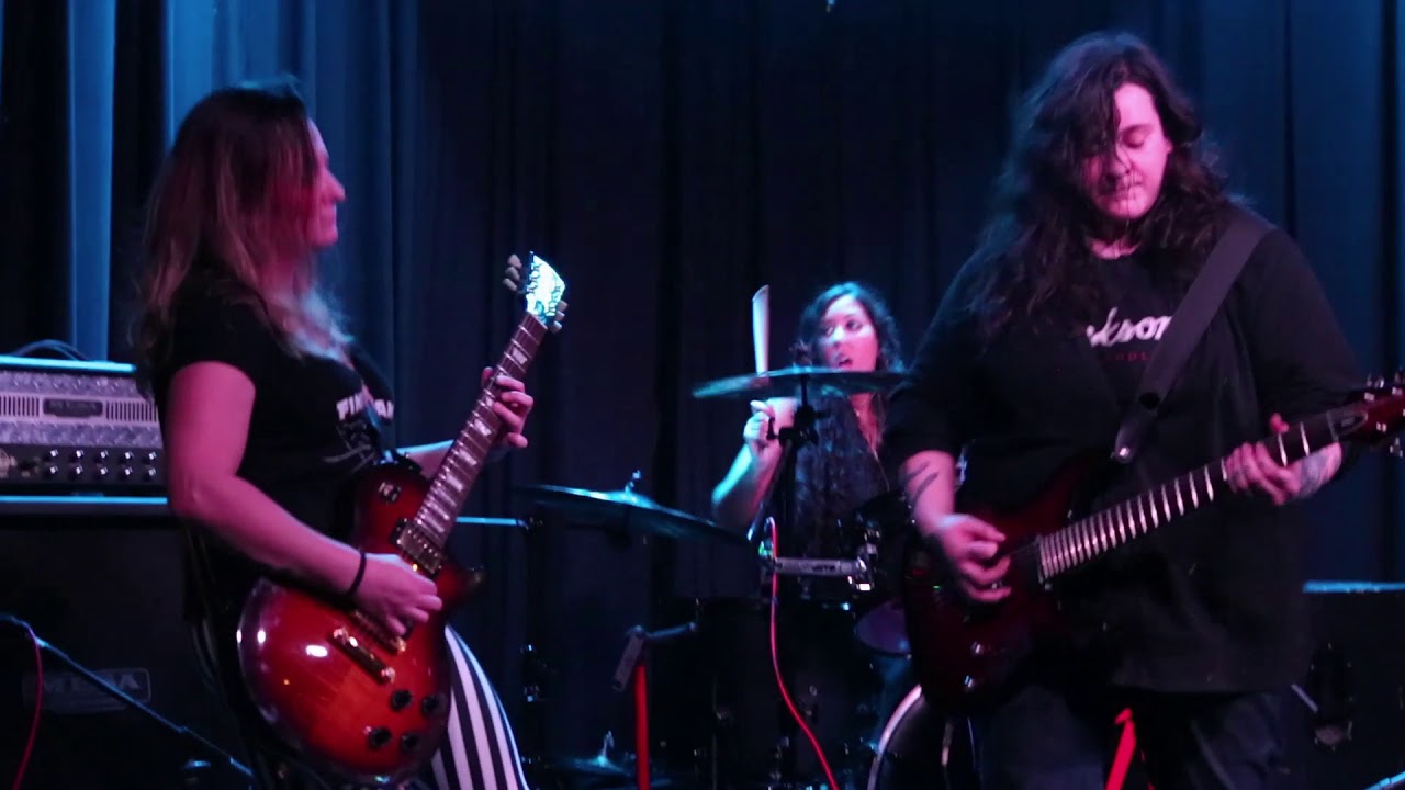 Atrocity Girl all-girl band playing 