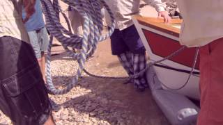 Roller Tubing A Dory Onto The Beach At Truck Stop Camp, Grand Canyon Dories