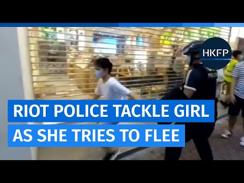 Hong Kong riot police tackle young girl in Mong Kok as she tries to flee