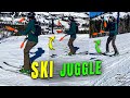 Snowskier Juggling 3 Clubs While Skiing