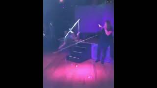 Woman pole dances and falls off stage