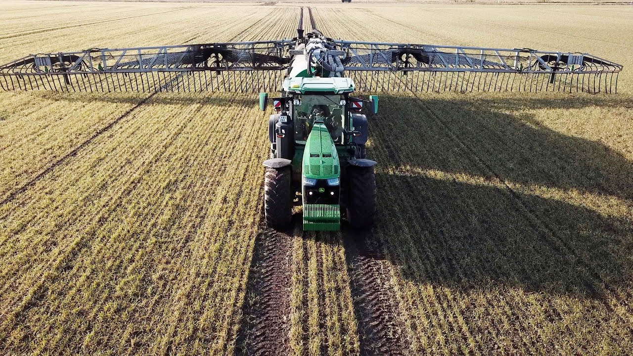 John Deere 8R 370 in field laying manure w/ Samson PG35 & PG31