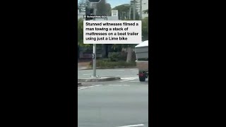 Man uses Lime bike to tow boat trailer in Queensland