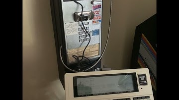 TRS-80 model 102 posting a message via payphone for BBS Week 8