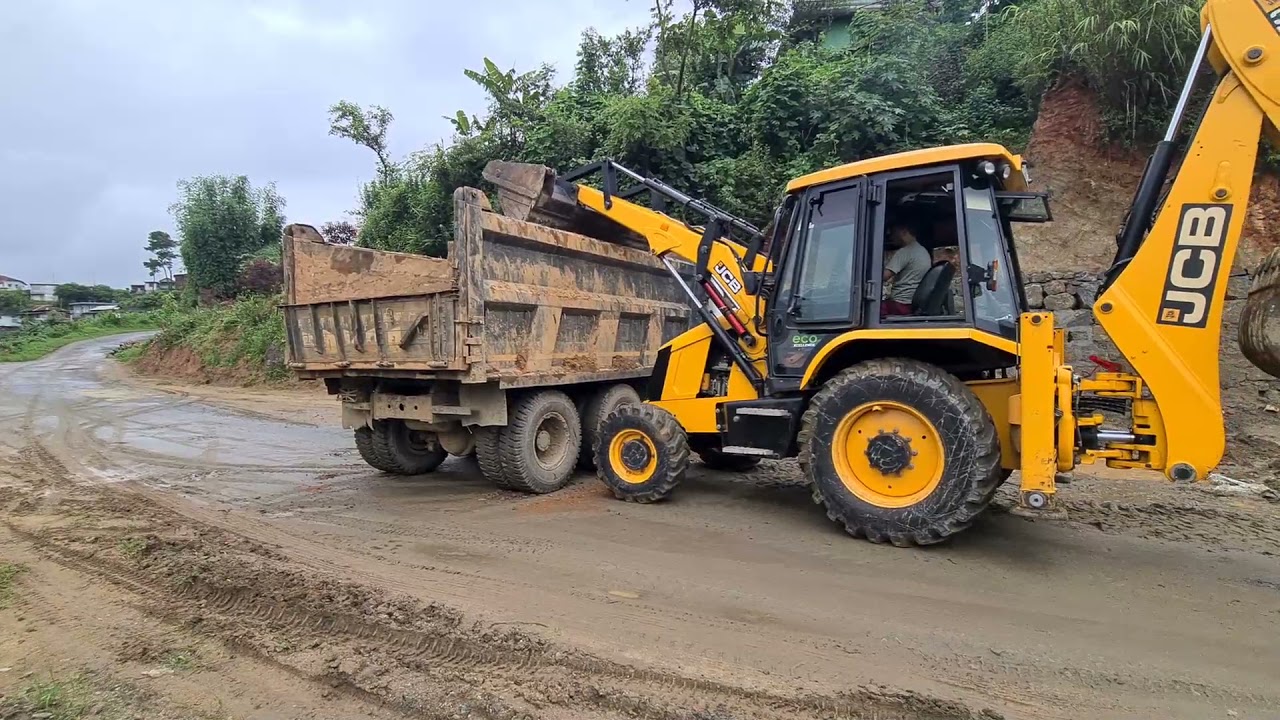 jcb loading boulder in a dump truck