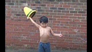 Genius three year old tries his best performing a juggling act.